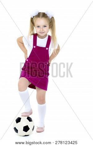 Adorable Little Girl With A Soccer Ball. The Concept Of Childrens Sports, Summer Outdoor Recreation.