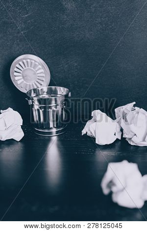 Garbage Bin On Desk Setting And Scrunched Paper Balls Around It, Concept Of Drafting And Struggling 
