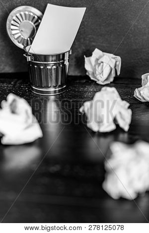 Garbage Bin On Desk Setting With Empty Notepad And Scrunched Paper Balls, Concept Of Drafting And St