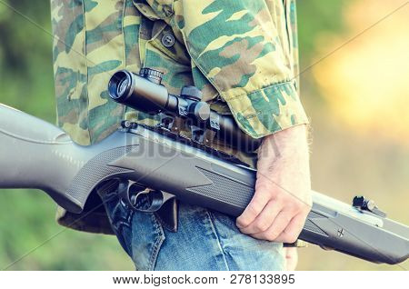 Male, Shooter Engaged In Sports Hunting With An Air Rifle In The Wild