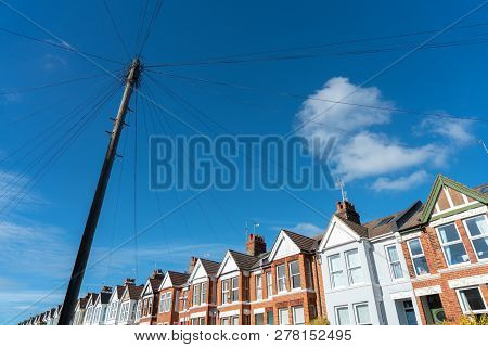 Old Vintage Wood Electric Poles Cable Construction Style In Townhouse Area In Uk. Pylon, Power Cable