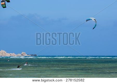 Mui Ne, Vietnam - 11 2018: Kitesurfing, Kiteboarding, Kite Surf. Extreme Sport Kitesurfing In Tropic