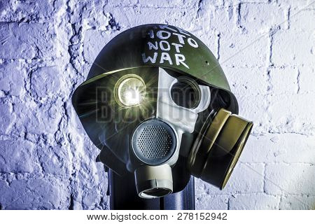 Art Picture Of A Military Gas Mask On A White Brick Wall With Shadows With Flash With The Inscriptio
