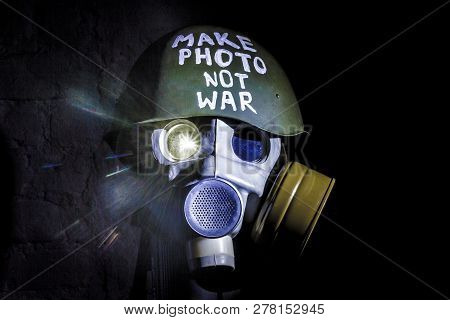 Art Picture Of A Military Gas Mask On A White Brick Wall With Shadows With Flash With The Inscriptio