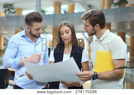 Group Of Young Modern People In Smart Casual Wear Having A Brainstorm Meeting While Standing In The 