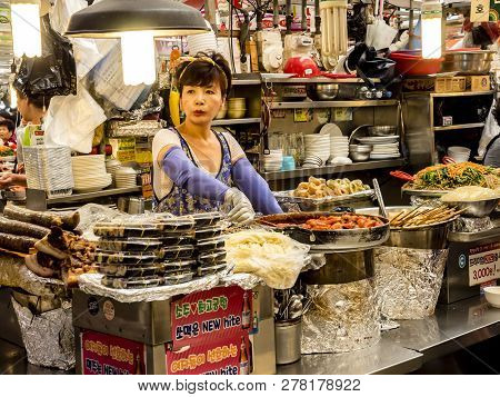 Seoul, South Korea - June 21, 2017: Woman Vendor Serving Customers At Gwangjang Market In Seoul.