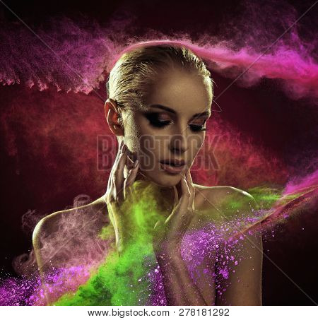 Portrait of beautiful woman , on a dark particles backbround