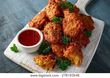 Crispy Onion Bhajis With Sweet Chilli Sauce On White Wooden Board