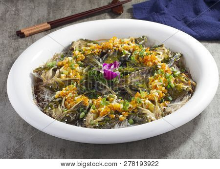 Steamed Little Yellow Croaker With Minced Garlic In A White Dish