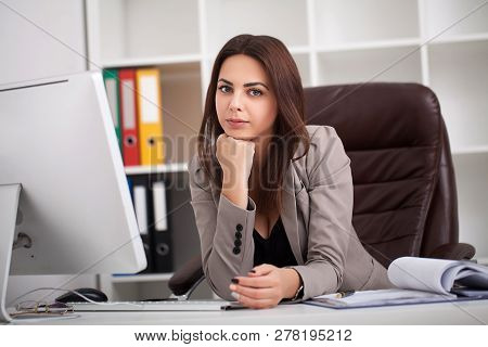 Headache And Stress At Work. Portrait Of Young Business Woman At Her Office