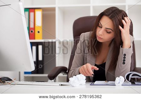 Headache And Stress At Work. Portrait Of Young Business Woman At Her Office