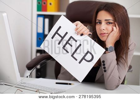 Headache And Stress At Work. Portrait Of Young Business Woman At Her Office