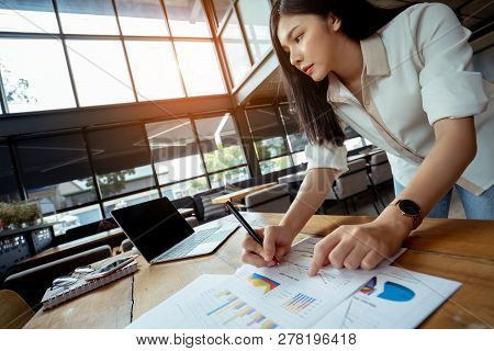 Business Analyzing Charts And Graphs Of Asian Businesswoman Her Hustle Writing Note With Digital Lap