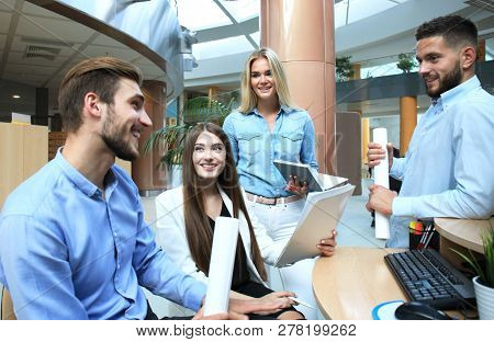 Group Of Young Modern People In Smart Casual Wear Having A Brainstorm Meeting While Standing In The 