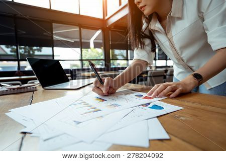 Business Analyzing Charts And Graphs Of Businesswoman Her Hustle Writing Note With Digital Laptop Co