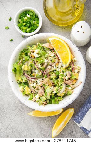 Salad With Tuna, Avocado, Onion, Egg And Lemon. Spring Healthy Delicious Lunch On Light Background