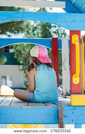 Lonely Child On The Playground In Cap
