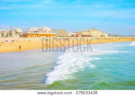 Costa Da Caparica, Lisbon, Portugal - September 17, 2018: People At City Beach In Evening Sunlight, 
