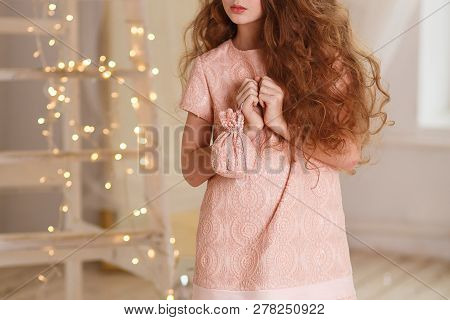 Girl With Lush Hair Index Finger To Lips On The Background Of Garlands
