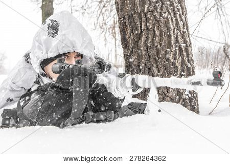 Closeup Man Soldier In The Winter On A Hunt With A Sniper Rifle In White Winter Camouflage And Equip