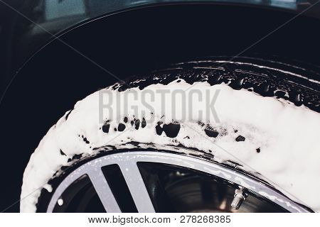 Car Care Or Car Detailing Process. Using Black Sponge To Washing The Tire. Blacker Rubber.