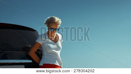 Adult Independent Woman Enjoys Road Adventure. Successful Woman Freedom Holidays Concept. Vacation, 