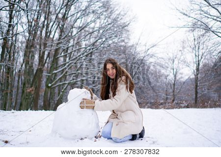 Enjoying Nature Wintertime. Winter Woman Happy. Beautiful Girl In The Winter Forest In White Down Ja