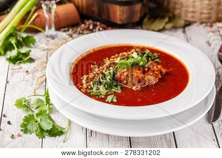 Traditional Georgian And Armenian Cuisine. Tomato Soup With Rice Harcho Of Lamb, With Walnut, Garlic
