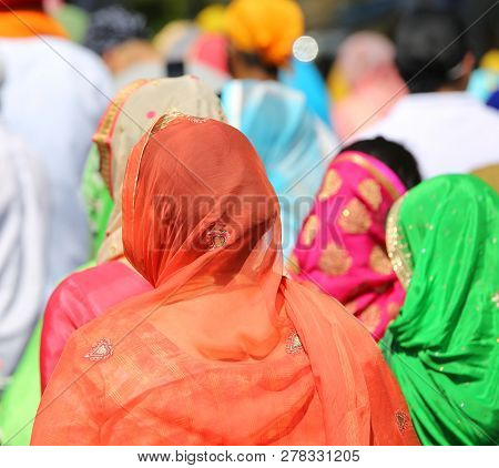 Women With Head Covered By A Veil During An Outdoor Parade
