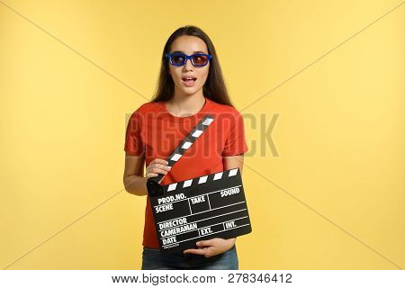 Woman With 3d Glasses And Clapperboard On Color Background. Cinema Show