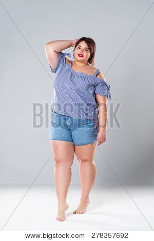 Plus Size Fashion Model In Jean Shorts, Fat Woman On Gray Studio Background, Overweight Female Body