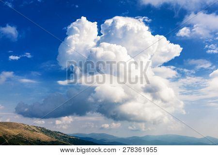 Beautiful Big Fluffy Cloud On Bright Blue Sky.