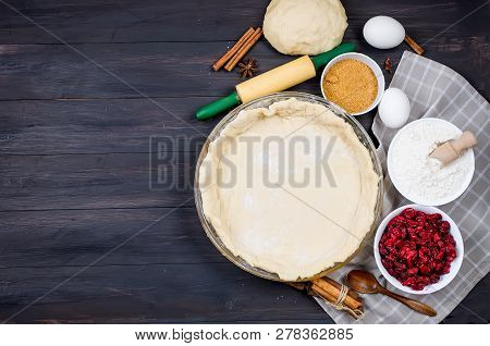 Pie Base In A Glass Round Form And Ingredients For Making Cake  - Flour, Egg, Cherry, Brown Sugar, C