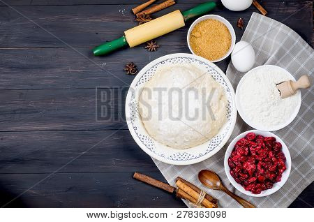Raw Dough In A Bowl And Ingredients For Making Cake  - Flour, Egg, Cherry, Brown Sugar, Cinamon On T