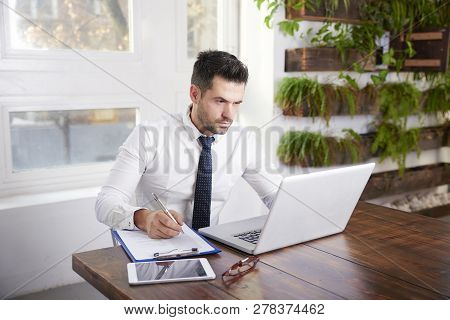 Businessman Using Laptop In The Office