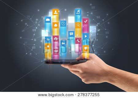 Businessman hand using phone with flying application icons around