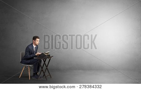 Man working hard on a typewriter in an empty space
