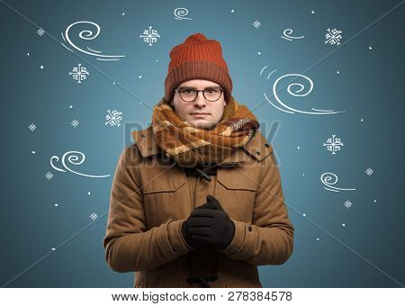 Young hipster frozen boy with doodled snowflakes and windy concept