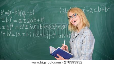 Woman Teaching Near Chalkboard In Classroom. Qualities That Make Good Teacher. Effective Teaching In