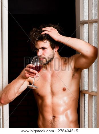 Man With Sexy Torso Drink Wine. Sexy Attractive Macho Tousled Hair Coming Out Through Bedroom Door. 