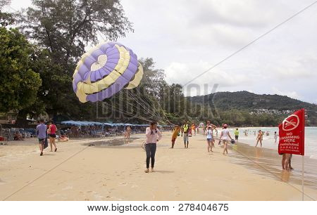 Kata Beach, Phuket, Thailand - June 15, 2018: Unidentified Tourists Prepare For Parasailing On Kata 