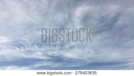 Beautiful Snowy Clouds Against A Blue Sky Background. Sky Cloud. Blue Sky With Winter Clouds Weather