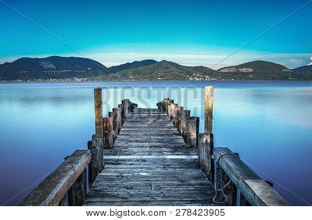 Wooden Pier Or Jetty On Blue Lake Sunset And Sky Reflection Water. Long Exposure, Versilia Massaciuc