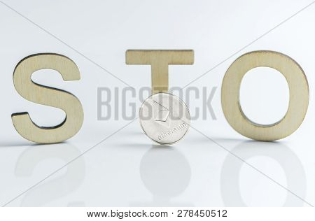 Security Token Offering Sto Sign With Wooden Letters And Silver Ethereum Coin, Ethereum Concept On W