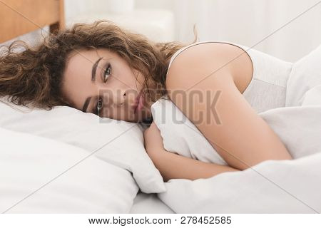 Depressed Young Woman Lying In Bed And Feeeling Upset After Quarrel With Her Boylfriend In Bed At Ho