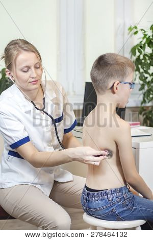Boy During The Medical Examination With A Stethoscope By The Pediatrician Deeply Breathes Through Th