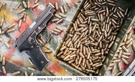 Top View Of Gun And Ammunition Box On The Table