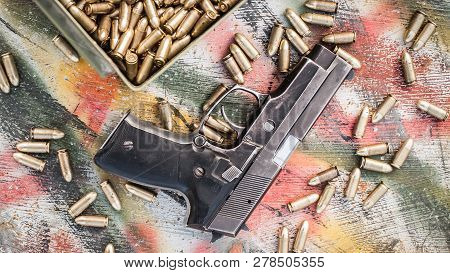 Top View Of Gun And Ammunition Box On The Table