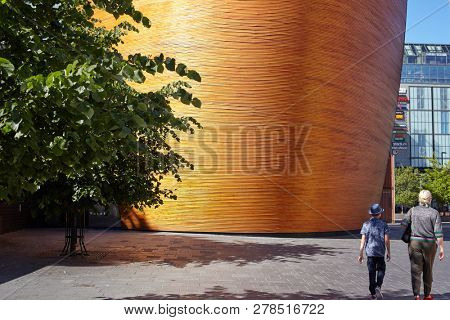 HELSINKI, FINLAND - JULY 16, 2017: People at Kamppi Chapel, also known as Chapel of Silence. It is intended to be a place to calm down and have a moment of silence in one of busiest areas in Finland