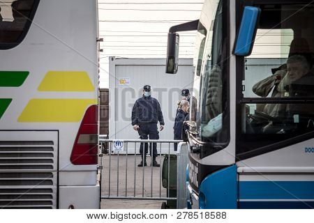 Sid, Serbia - November 14, 2015: Serbian Policeman Standing In Front Of Buses Of Refugees Waiting To